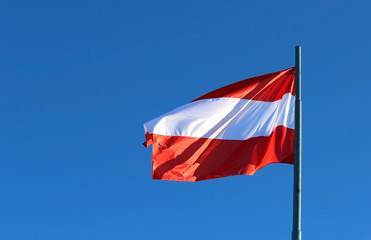 great Austrian flag waving in the blue sky