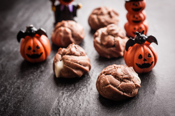 Eclairs with halloween decoration on black background
