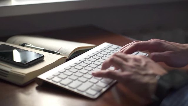 Professional designer or artist using laptop and digital graphic tablet while working at vintage loft,young male freelancer working on portable computer at home interior, orange bike in the background