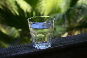 Ice cold water cup on the exotic background