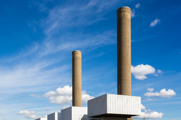 Chimneys of a coal fired power station against blue sky