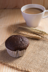 Cupcake on fabric  with coffee cup background.