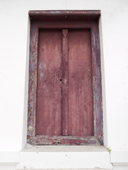 brown wooden door in a white wall