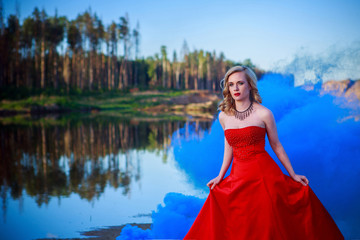Fototapeta premium Portrait of beautiful girl in red dress in nature