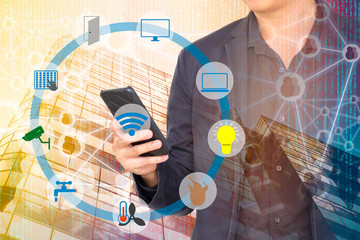 Smart Building and Internet of Things concept. Smart building management icons on Double exposure of Business man, office building and abstracy digital connection background.