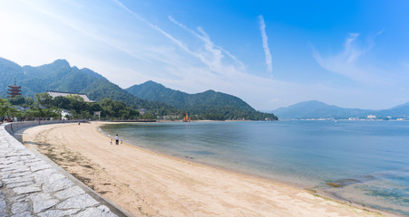 Scenery of sea coast on Miyajima Island viewing the famous orange floating Japanese shinto gate...