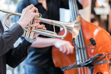 Hands of the man playing the trumpet
