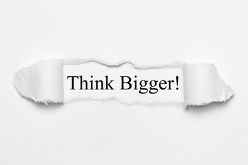 Fototapeta premium Think Bigger! on white torn paper