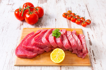 Raw tuna steak on wooden cutboard
