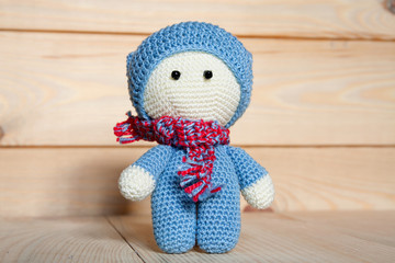 Crochet soft toy on a wooden background