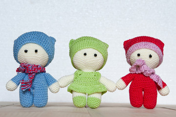 Three variegated crochet soft toys on a light background