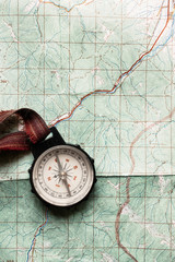 wanderlust and explore concept, old compass lying on map, top vi