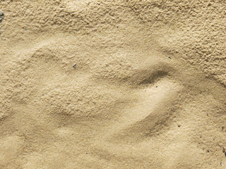 closeup of sand pattern of a beach in the summer