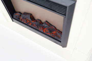 Closeup of electric artificial fireplace with burning logs