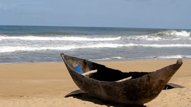 Traditional wooden hand made African / Malagasy fishing boat - piroga on the sandy beach of Indian ocean in Madagascar, Africa