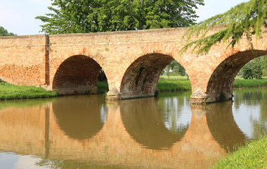 bridge made of red brick with arches