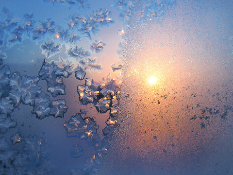 Ice pattern and sunlight on winter glass