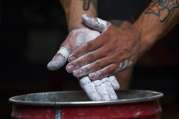 Closeup of male hands with talc powder.
