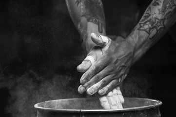 Male athlete clapping hands with talc powder
