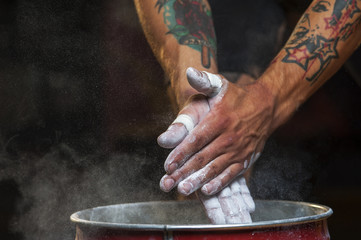 Male hands with talc powder.