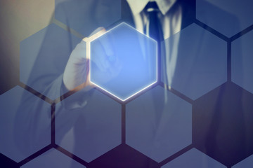 Businessman using pen stylus touching on technology honeycomb interface on virtual screen