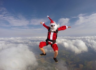 Santa jumping with a parachute - obrazy, fototapety, plakaty