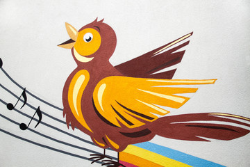 Mural of bird singing with notes and ledger lines - 124019774