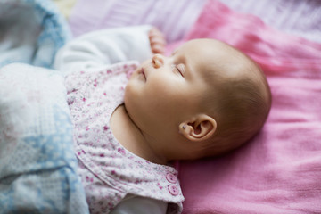 Cute sleeping baby lying on bed