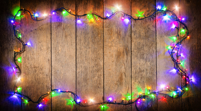 Christmas colored lights with decoration on wood