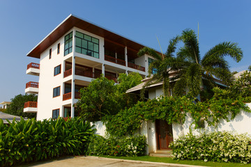 Beautiful modern townhouses against blue sky.