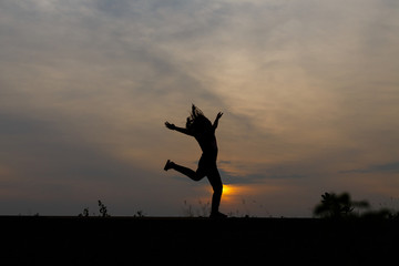 Silhouette girls on holiday. she is happy to be running and jump