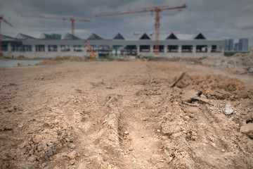 Fototapeta na wymiar Construction site / View of ground with blur construction site background. Dark tone.