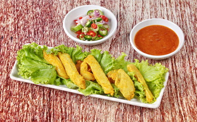 Charcoal boiled pork satay served with Thai cucumber chili sauce 