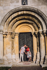 Young couple near old wooden door.