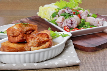 Close up of gold bar soup as fried tofu wrap minced pork in soup and coriander on bamboo. Selective focus