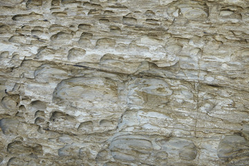 A full page of white rock with eroded holes background texture
