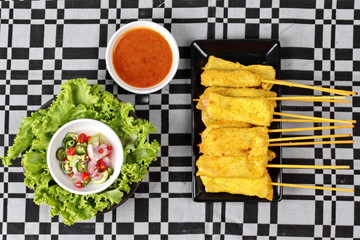 Charcoal boiled pork satay on butcher served , home made in big size, served with Thai cucumber chili sauce as 