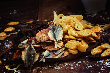 Dried fish and crackers. Vintage wooden background, selective fo