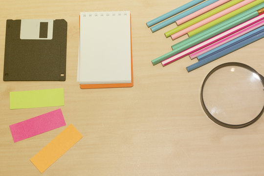 Office desk with group of pencil,glass,diskett and lens,group of note,colorful of note,