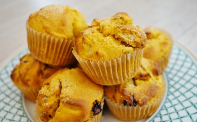 Platter of homemade vegan pumpkin muffins with pears and dried cherries