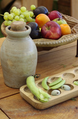 Pottery jug with fruit and peas