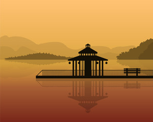 landscape - silhouette of a house on a background of mountains, sky with reflection in water.