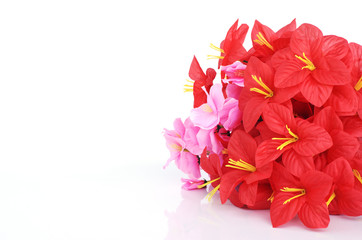 Red and pink plastic flowers Ioslated on white backgrounds