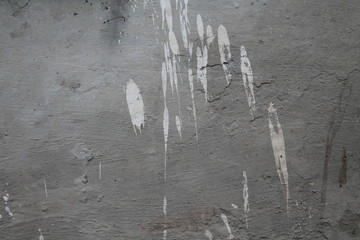 Concrete grey wall with splashes of white paing