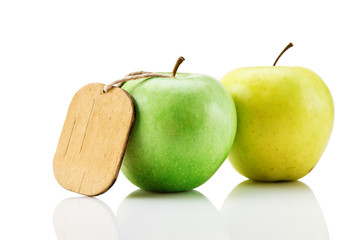 two green apple with tag isolated on white background