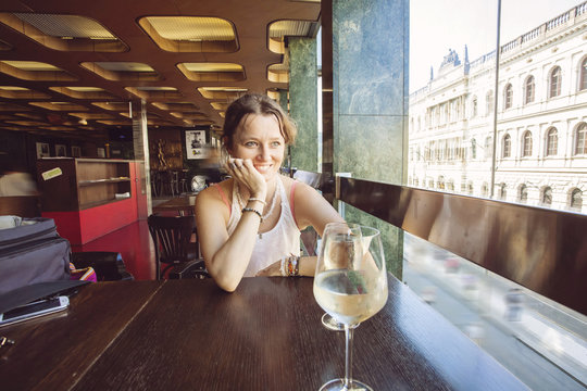 Woman in restaurant with glass of wine