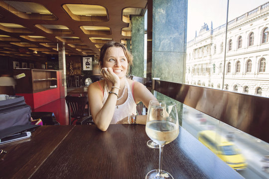 Woman in restaurant with glass of wine
