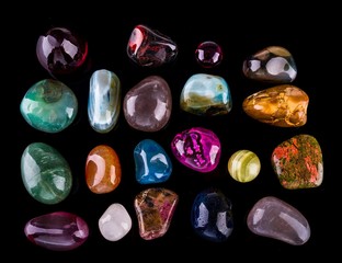 Collection of Colorful Semiprecious Gemstones on Black Background.