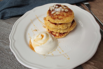 Russian sweet cheese pancakes with sour cream for Breakfast or a snack - it's delicious