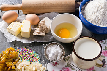 Ingredients for baking yeast cake, wooden background.